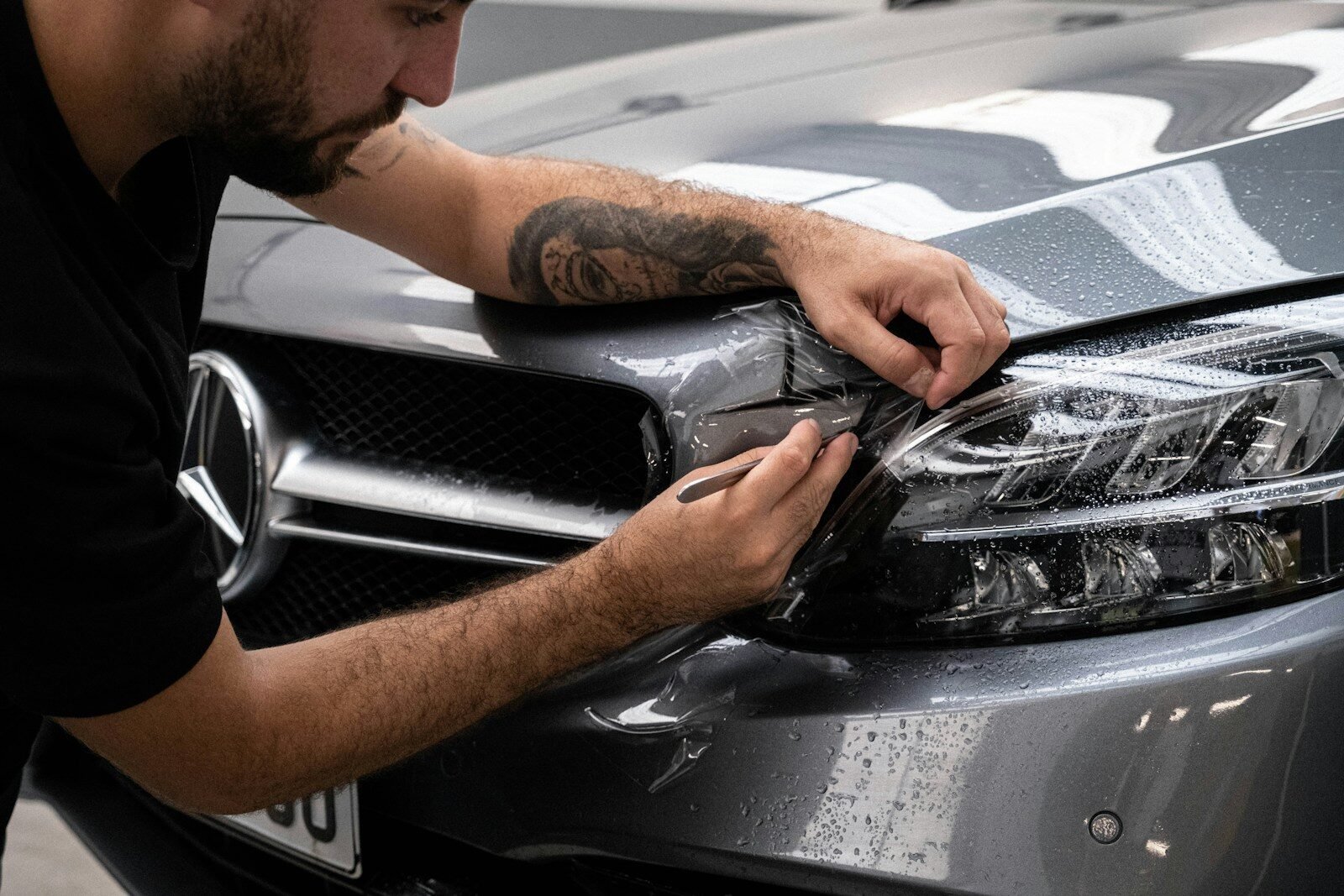 Man waxing car hood detailing in Canberra