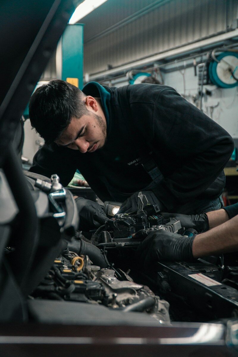 Mechanic working on car engine in Perth