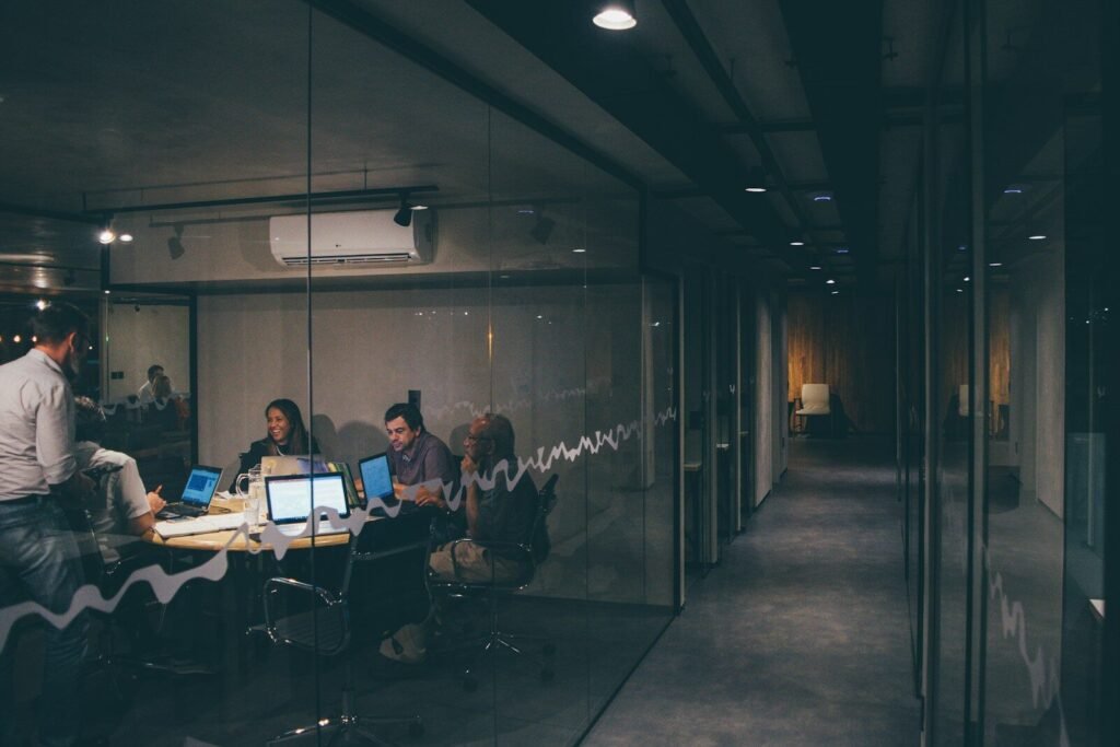 Odoo ERP implementation – business team using business management software and ERP tools in a dark office meeting