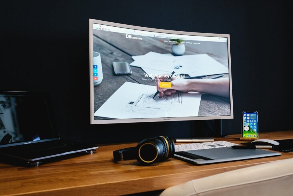 Web design and development services - dark designer workspace with website on screen